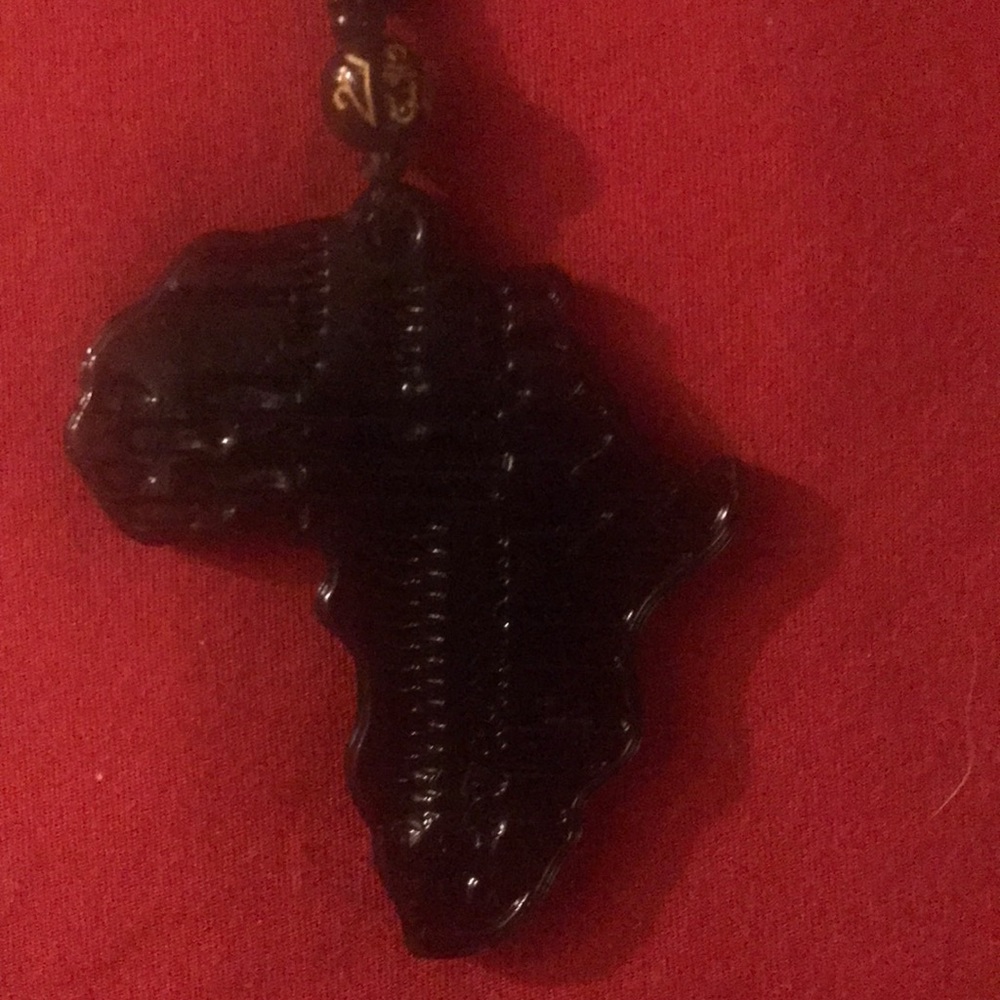 This is an all black ceramic Africa necklace